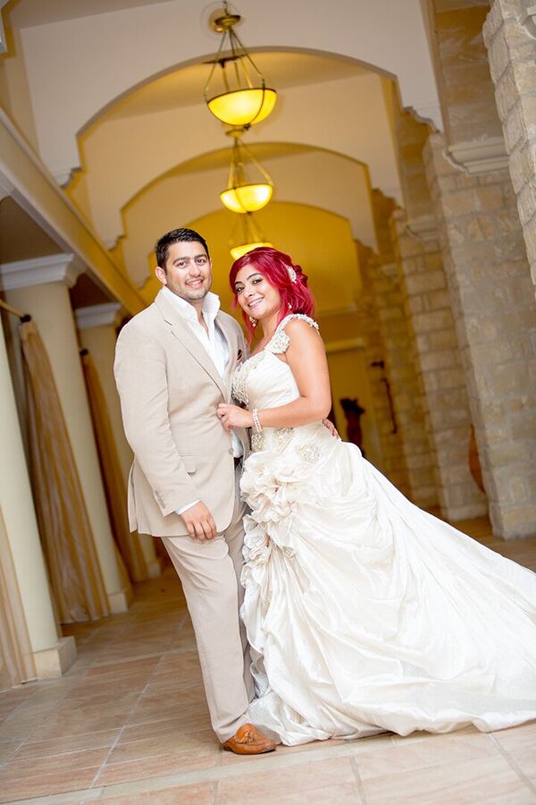 Bride and groom in an arched hallway at The Elysium, Paphos, photographed by Evagoras Mandrides