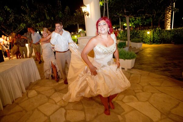 The bride dancing at an outdoor wedding reception in Paphos, photographed by Evagoras Mandrides