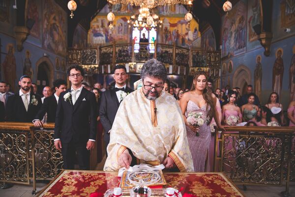 The priest during a Greek Orthodox wedding ceremony in Brookmans Park, photographed by Evagoras Mandrides