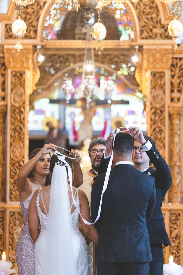 The crowning at a Greek Orthodox wedding at the Twelve Apostles, Brookmans Park, photographed by Evagoras Mandrides