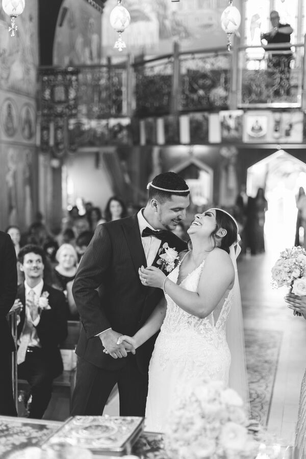 Bride and groom at the end of a Greek Orthodox wedding ceremony in North London, photographed by Evagoras Mandrides