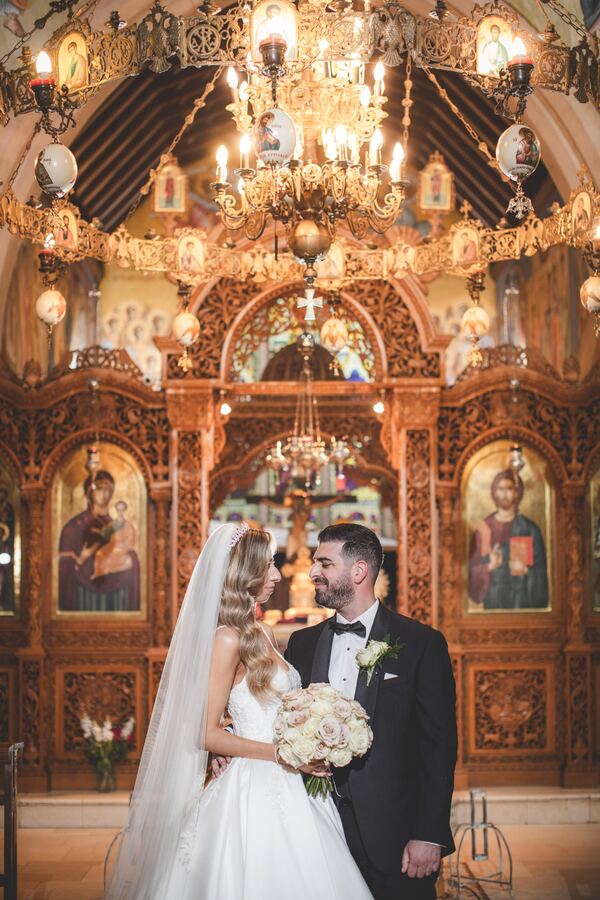 Bride and groom in front of the iconostasis at the Twelve Apostles, Brookmans Park, photographed by Evagoras Mandrides