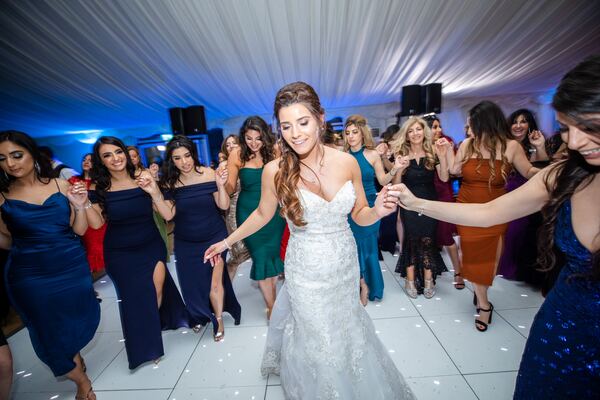 The bride dancing at a Greek Cypriot wedding reception at Hylands House, photographed by Evagoras Mandrides