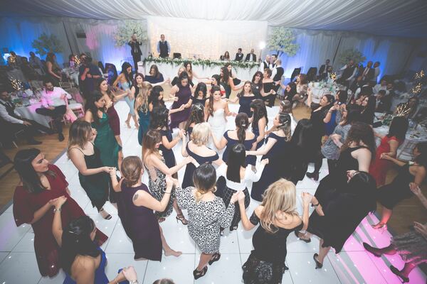 Guests dancing at a Greek Cypriot wedding at Hylands House, Essex, photographed by Evagoras Mandrides