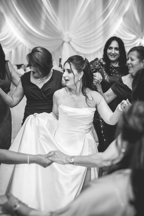 The bride dancing the kalamatiano at an Essex wedding reception, photographed by Evagoras Mandrides