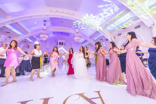 Guests dancing the kalamatiano at a North London wedding, photographed by Evagoras Mandrides