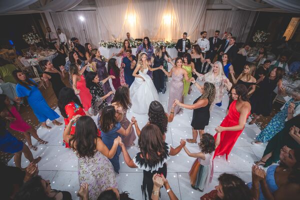 Guests dancing the kalamatiano at a Hertfordshire wedding reception, photographed by Evagoras Mandrides