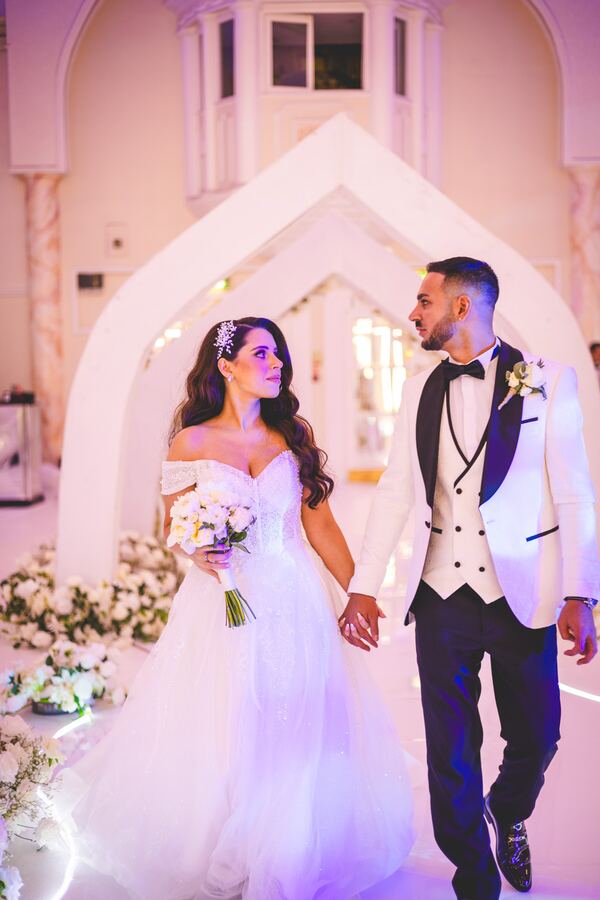 Bride and groom in the decorated reception room at a North London wedding, photographed by Evagoras Mandrides